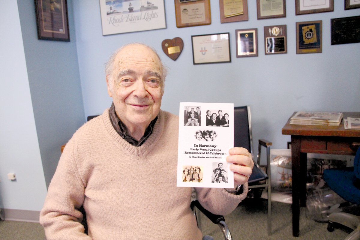 SHARING HIS PASSIONS: Lloyd Kaplan is pictured with a copy of his newest book, “In Harmony: Early Vocal Groups Remembered & Celebrated,” which was co-authored by Tom Shaker. (Beacon Communications photo)